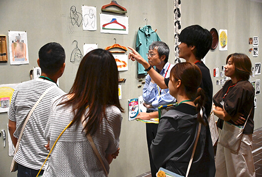展示室で作品を指さしながら意見を交わすとびラーたち