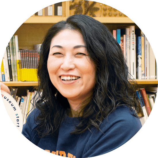 40代くらいの女性 長いウェーブの髪で穏やかに微笑む姿